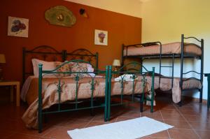 two bunk beds in a room with orange walls at Antico Frantoio Rooms in Sambuca di Sicilia