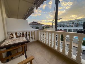 a balcony with a bench and a view of a building at Casa Di Mare in Olympic Beach