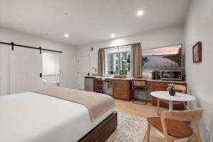 a bedroom with a bed and a desk and a kitchen at Bella Notte by the Beach in Santa Cruz