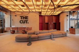 a living room with a couch in the middle at The Cut Hotel in Medellín