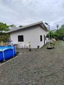 a white building with a pool in front of it at El Gato de la Jungla in Lagunillas