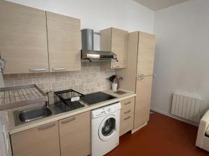 a small kitchen with a washing machine in it at GITE chez "Chambre D'Hôtes Sandra" in Annot
