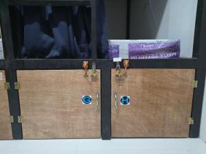 a pair of wooden doors with keys on them at 7641guesthouse in Basdiot