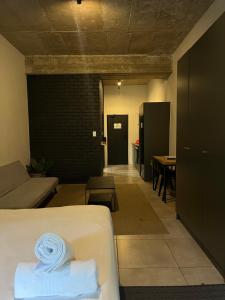 a room with a bed and a living room with a table at Sandton CBD apartment in Johannesburg