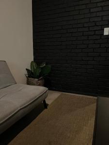 a living room with a couch and a brick wall at Sandton CBD apartment in Johannesburg +30 photos