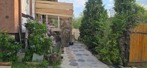 a garden path with flowers and a fence at Apartament Wilhelma II in Ząbkowice Śląskie