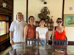 a group of people standing next to a glass table at Traditional Houseboat in Alleppey