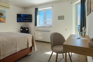 a bedroom with a bed and a table and chairs at B&B Villa Marta - New Opening 2026 in Medulin