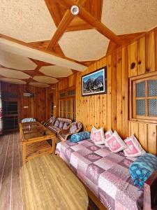 a bedroom with two beds in a wooden room at Himalaya Vista - 1km Uphill Hike from Main Road in Harsil +55 photos