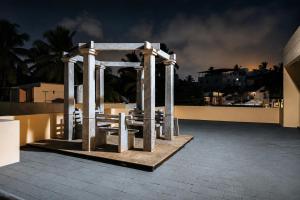 a gazebo on the roof of a building at night at Prana pulse villa stay gokulam in Mysore