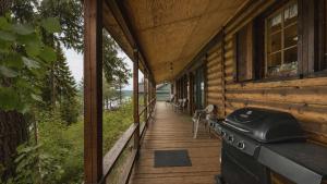 a porch of a wooden house with a phone on it at McCall Lakehouse Private Dock Beach & Grill in McCall