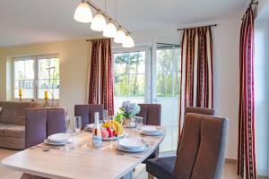 a dining room with a table and chairs at Ferienhaus Seegras in Groß Kirr