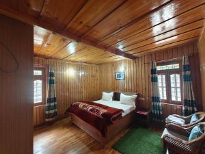 a bedroom with a bed in a wooden cabin at Himalaya Vista - 1km Uphill Hike from Main Road in Harsil