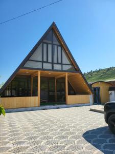a large building with a gambrel roof at Shabran Pearl A-Frame in Surra