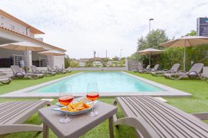 a table with two glasses of wine and a bowl of food at Le dune relax con cucina & piscina in San Teodoro +117 photos