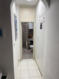 a hallway leading to a bathroom with a toilet at Apartman Dunjićeva in Kotor