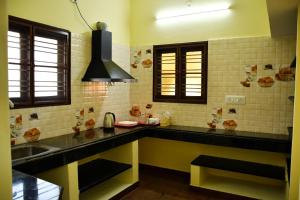 a kitchen with a sink and a counter top at Srinivasam service apartment in Madurai +5 photos