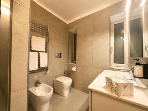 a bathroom with a toilet and a sink and a mirror at iPrincipati Luxury Living Suite in Salerno +29 photos