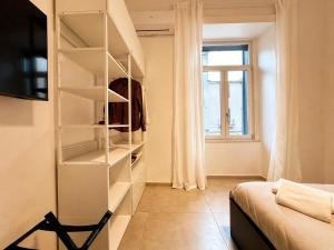 a room with a closet with shelves and a window at iPrincipati Luxury Living Suite in Salerno