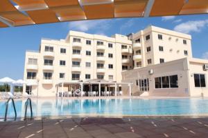 a large swimming pool in front of a building at Kama Lifestyle Apartments in Protaras