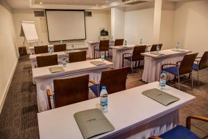 a conference room with tables and chairs with water bottles on them at Hotel Beyond in İzmir