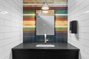 a bathroom with a sink and a mirror at Chic Glamping Tent with Firepit in Branson +17 photos
