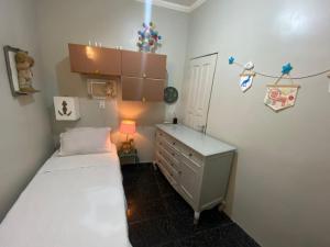 a small bedroom with a bed and a dresser at BACKHOUSE Vieiralves - Manaus in Manaus