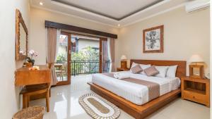a bedroom with a bed and a balcony at Sriwedari 40 Ubud in Ubud