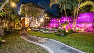a villa with a swimming pool at night at Sriwedari 40 Ubud in Ubud