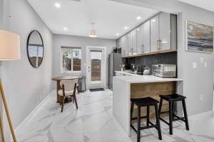 a kitchen with a counter and two stools at Marina Row 4 Beach Shops in Delray Beach