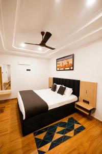 a bedroom with a bed and a ceiling fan at Hotel The Edge in Rewa