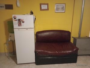 a white refrigerator next to a brown leather chair at Hospedaje DON MANUEL in Paso de Indios +8 photos