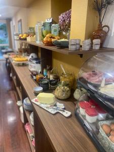 a row of shelves with food on them at Louis Hotel in Perros-Guirec +39 photos