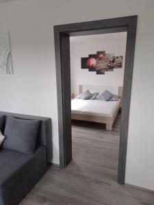 a mirror in a room with a bed and a couch at Vejminek 87 in Červená Třemešná