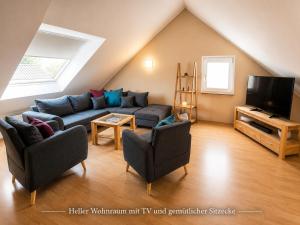 a living room with a couch and a tv at Ostseeferienhaus Usedom Lütow am Achterwasser Hundefreundlich Naturlage Familie Christian Ziethen in Lütow
