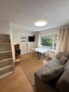 a living room with a couch and a table at Domek letniskowy Wielonek 4 in Cierplewo