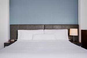 a bedroom with a large white bed with a blue wall at Element by Marriott Arundel Mills BWI Airport in Hanover +33 photos