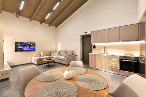 a kitchen and living room with a table and chairs at Vagg Villas in Preveza