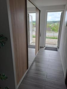 a hallway with two windows and a mirror at Vejminek 87 in Červená Třemešná +2 photos