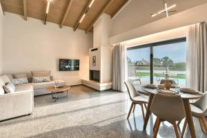 a living room with a table and a couch at Vagg Villas in Preveza