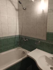 a bathroom with a tub and a shower and a sink at Къща за Гости ,,Afrikana,, in Sveti Vlas