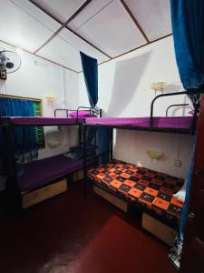 a room with two bunk beds and a mirror at Echo Point in Trincomalee