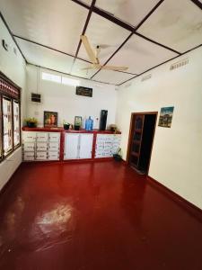 an empty room with a kitchen with a ceiling fan at Echo Point in Trincomalee