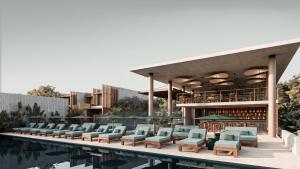 a swimming pool with lounge chairs and a library at NANANA Hotel de Mar - Solo Adultos in Puerto Escondido