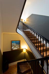 a staircase leading up to a living room with a view of a balcony at Hostel Alegria in Porto