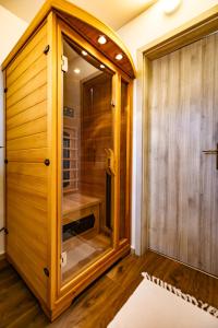 a walk in shower with a glass door in a room at Gémes Vendégház in Vitnyéd +108 photos