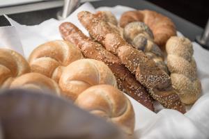a tray of different types of breads and pastries at Muttererhof in Innsbruck +26 photos