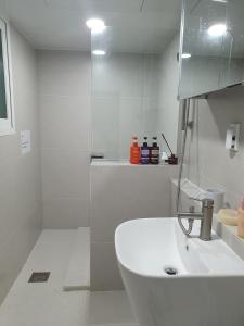 a white bathroom with a sink and a shower at 상록수 sangroksu in Boeun +19 photos