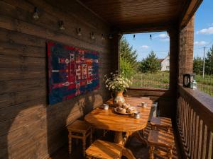 a wooden table on the back porch of a cabin at Eco house in Szack