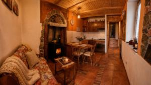 a living room with a couch and a kitchen at Rustico Verginate in Bellano